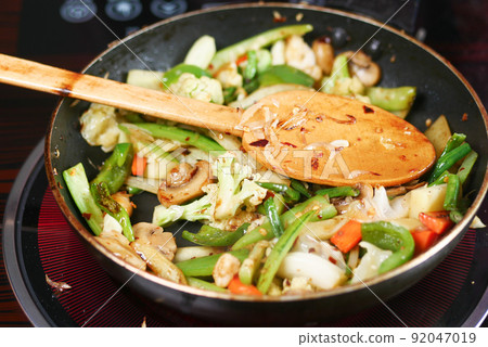cooking fresh vegetable in a cooking pan cooking fresh vegetable in a cooking pan 92047019