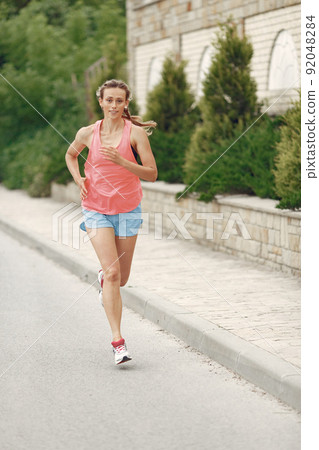 Sports girl. Woman in a summer city. Lady in a sportswear. 92048284
