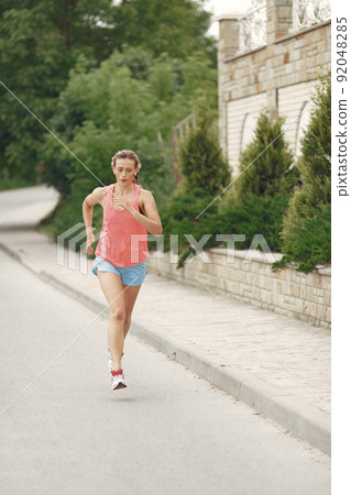 Sports girl. Woman in a summer city. Lady in a sportswear. 92048285