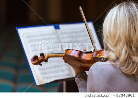 Philharmonic orchestra playing on the violoncello, performance concert, classical music concept Philharmonic orchestra playing on the violoncello, performance concert, classical music concept 92048901