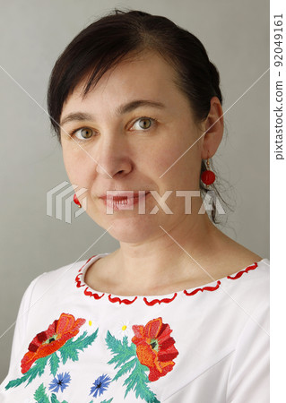 Portrait of a beautiful woman with embroidered shirt Portrait of a beautiful woman with embroidered shirt 92049161
