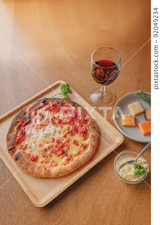Authentic pizza and red wine baked in a stone oven Authentic pizza and red wine baked in a stone oven 92049234
