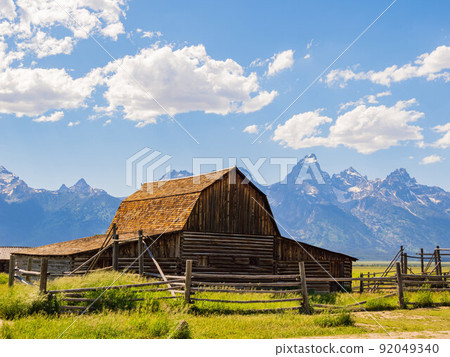Sunny view of the John Moulton Barn and Teton Range 92049340