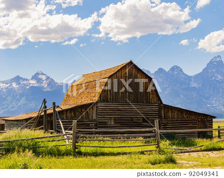 Sunny view of the John Moulton Barn and Teton Range 92049341