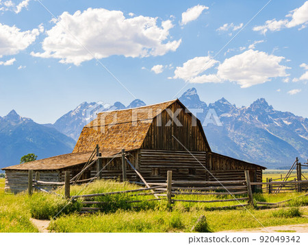 Sunny view of the John Moulton Barn and Teton Range 92049342