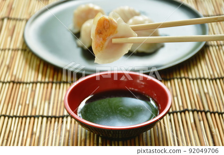 Ha Kao or white dumpling stuffed shrimp and pork on plate dipping soy sauce Ha Kao or white dumpling stuffed shrimp and pork on plate dipping soy sauce 92049706