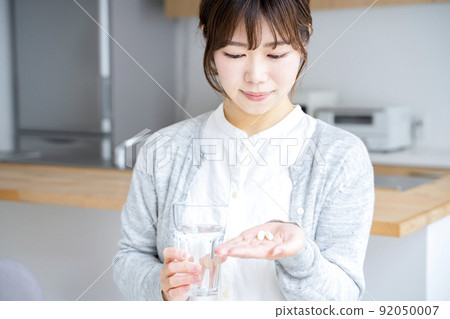 A woman drinking supplements 92050007