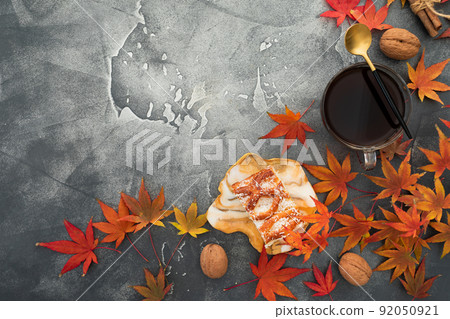 Autumn frame composition. Fall maple leaves with walnuts, cup of coffee and resin art plate on stone background. Autumnal thanksgiving day concept. Flat lay Autumn frame composition. Fall maple leaves with walnuts, cup of coffee and resin art plate on stone background. Autumnal thanksgiving day concept. Flat lay 92050921