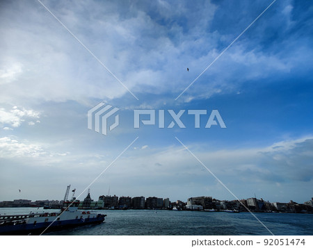 Seagulls flying and Fishing by the sea side with the background of the ocean and the blue sky Seagulls flying and Fishing by the sea side with the background of the ocean and the blue sky 92051474