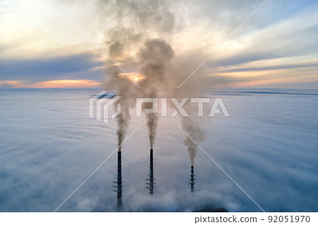 Coal power plant high pipes with black smoke moving upwards polluting atmosphere. Production of electrical energy with fossil fuel concept 92051970