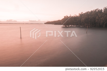 Long exposure of calm sea on horizon at dusk at mangrove forest nature backgound Long exposure of calm sea on horizon at dusk at mangrove forest nature backgound 92052015