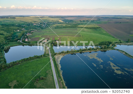 Aerial view of fish hetching pond with blue water in aquacultural area Aerial view of fish hetching pond with blue water in aquacultural area 92052740