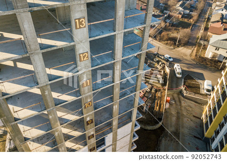 Aerial view of concrete frame of tall apartment building under c Aerial view of concrete frame of tall apartment building under c 92052743