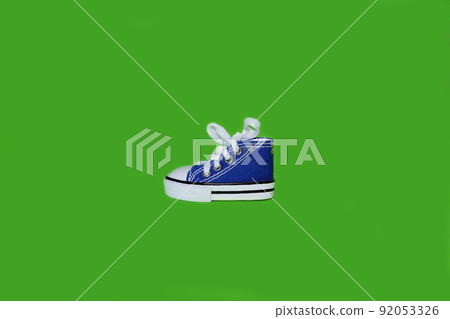 Sneakers on a bright green background 92053326