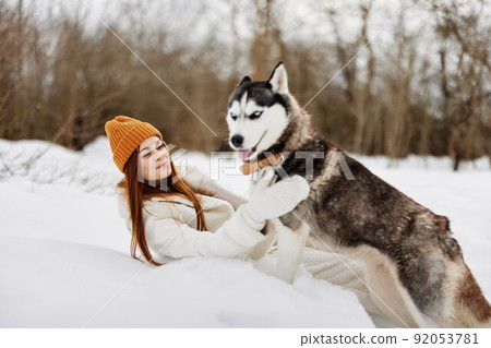cheerful woman winter clothes walking the dog in the snow fresh air cheerful woman winter clothes walking the dog in the snow fresh air 92053781