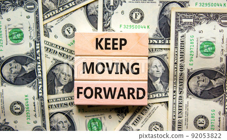 Keep moving forward symbol. Concept words Keep moving forward on blocks on beautiful background from dollar bills. Business, motivation and keep moving forward concept. Copy space. 92053822