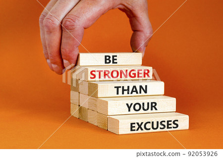 Be stronger symbol. Concept words Be stronger than your excuses on wooden blocks on a beautiful orange table orange background. Businessman hand. Business motivational and be stronger concept. Be stronger symbol. Concept words Be stronger than your excuses on wooden blocks on a beautiful orange table orange background. Businessman hand. Business motivational and be stronger concept. 92053926