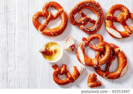 pretzels in the form of knot with cheese sauce pretzels in the form of knot with cheese sauce 92053997
