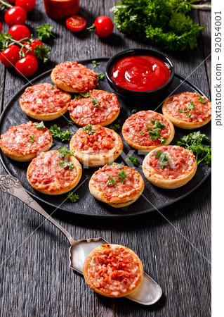 mini pizzas with ham and pecorino cheese, top view mini pizzas with ham and pecorino cheese, top view 92054001