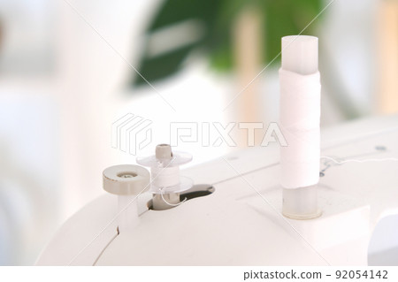 Winding threads on a bobbin on sewing machine. Winding threads on a bobbin on sewing machine. 92054142