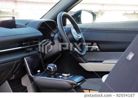 Inside the car: The driver's seat of the car as seen from the passenger side 92054187