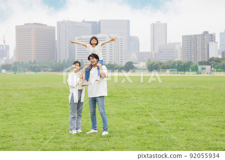 Parent-child piggyback playing in the park 92055934