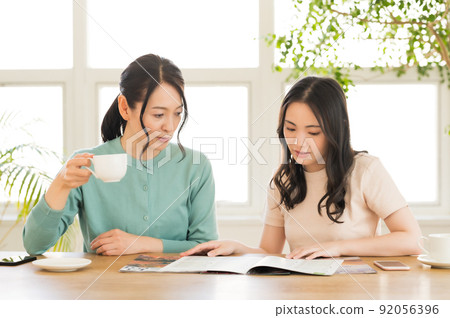 Parents and children working on travel francs while looking at the pamphlet Parents and children working on travel francs while looking at the pamphlet 92056396