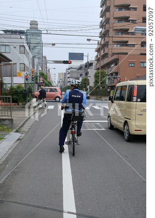 Policeman traveling by bicycle Policeman traveling by bicycle 92057097