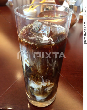 A glass of cold iced coffee mixed with milk A glass of cold iced coffee mixed with milk 92057656