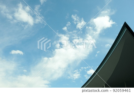 Clouds of various shapes and colors floating in the blue sky 92059461