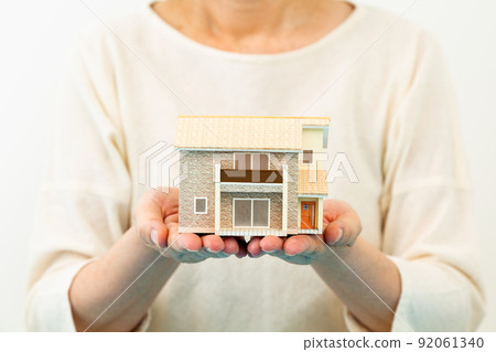 Middle woman with a house model 92061340