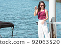 Asian woman travel and waiting for boat near river 92063520
