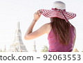 Woman wearing hat, sitting near river and travelling 92063553