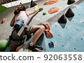A girl climbing rock mountain 92063558