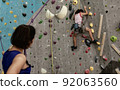 A girl climbing rock mountain 92063560