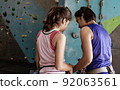 Mother teaching her daughter for rock climbing 92063561
