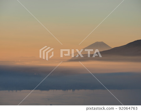 Overlooking the Suwa Basin and Mt. Fuji at sunrise from Shiomine Onorate Park in winter Overlooking the Suwa Basin and Mt. Fuji at sunrise from Shiomine Onorate Park in winter 92064763