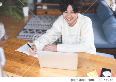 Young man studying computer 92065038