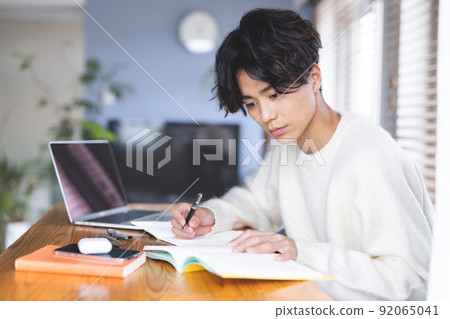 Young man studying computer 92065041