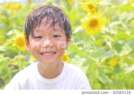 Sunflower and smiling boy 92065116