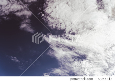 Cloudy sky. Clouds in the dark sky.  Pre-threatening weather. Before the storm. Beautiful natural background. Tinted photo. Natural background with copy space for text and design elements. 92065218