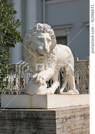 ancient lion sculpture made of stone. vertical shot of lion statue, travel in Europe, classic architecture and odl buildings sightseeing. ancient lion sculpture made of stone. vertical shot of lion statue, travel in Europe, classic architecture and odl buildings sightseeing. 92066631