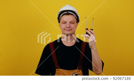 Electrician or handyman holds tools for working with electricity in his hands 92067180
