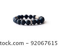 Bracelet made of dark navy natural stone on a white background 92067615