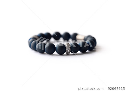 Bracelet made of dark navy natural stone on a white background 92067615