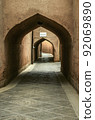 Secret streets, labyrinths paved with stone tiles, among windowless houses covered with adobe arches  in the city of Yazd. 92069890