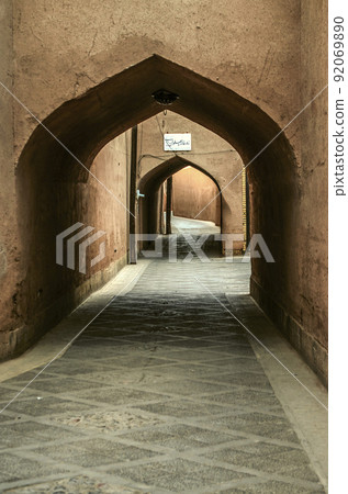 Secret streets, labyrinths paved with stone tiles, among windowless houses covered with adobe arches in the city of Yazd. Secret streets, labyrinths paved with stone tiles, among windowless houses covered with adobe arches in the city of Yazd. 92069890