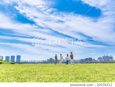 Three generations of families walking hand in hand in the park 92070312