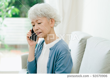 Senior woman receiving sad news [smartphone] 92070906