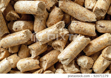 Macro background of wooden pellets. Compacted sawdust granules texture. Macro background of wooden pellets. Compacted sawdust granules texture. 92071179